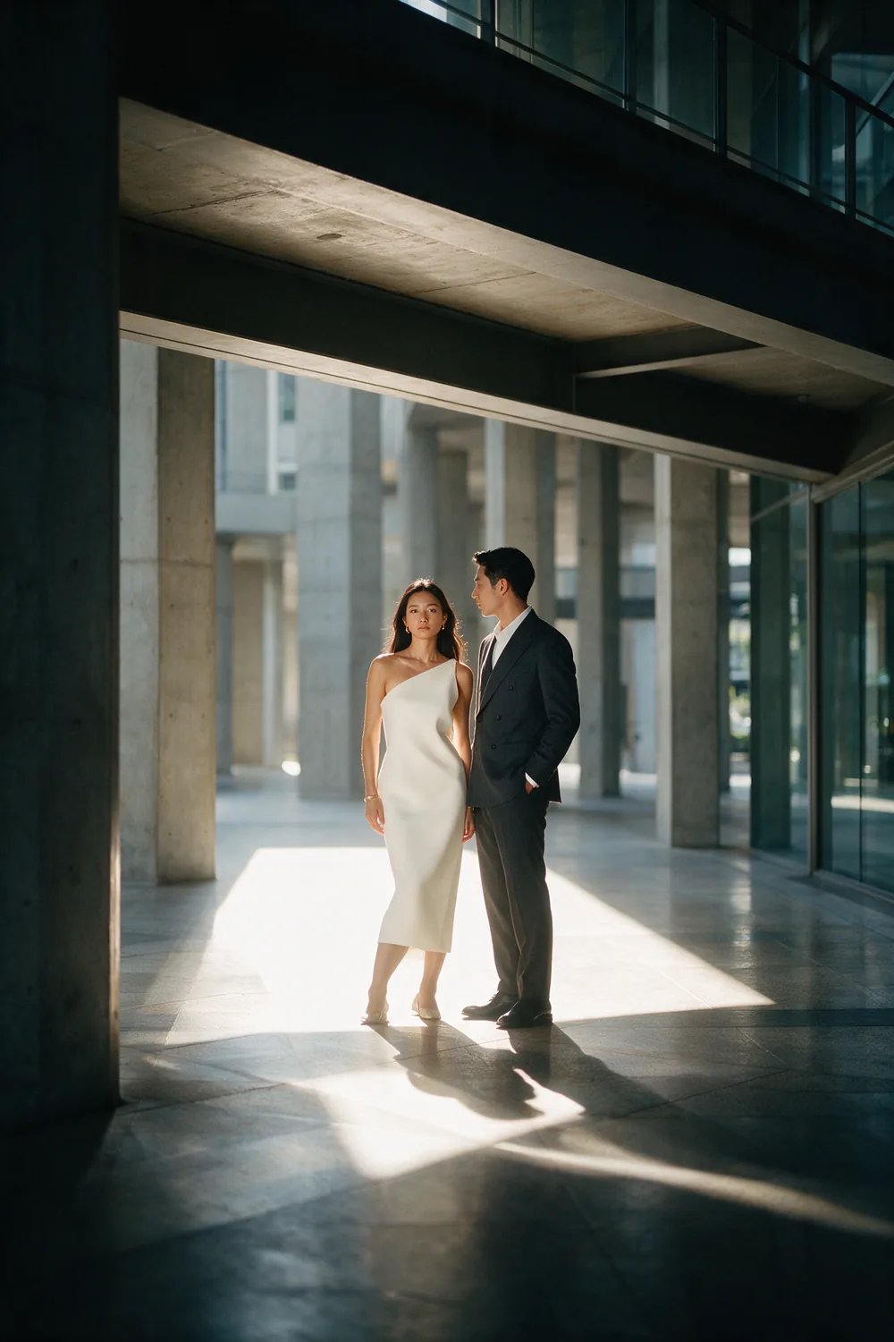 A concrete colonnade, light laid across the floor.