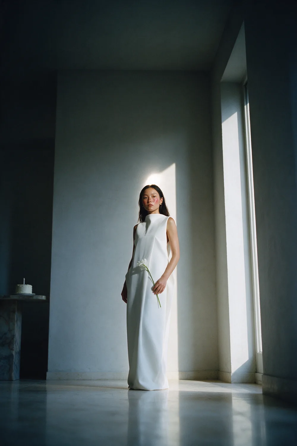 An empty room, one window, one figure.