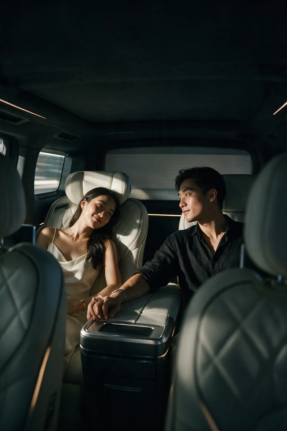 Inside a car at night, the two of them close.